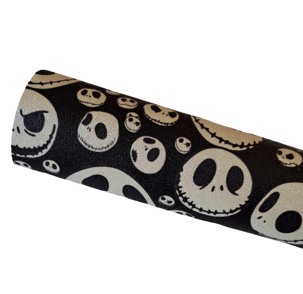 roll of black fine glitter fabric with white skull patterns on a white background