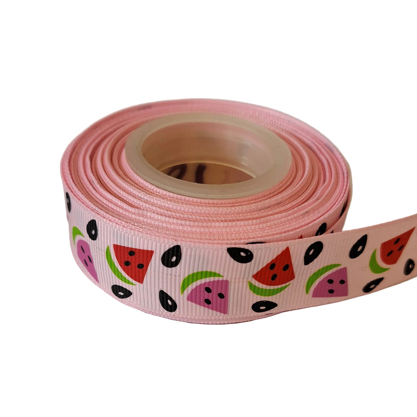 Roll of pink ribbon with watermelon pattern on a white background