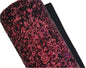 Roll of red glittery fabric on a white background