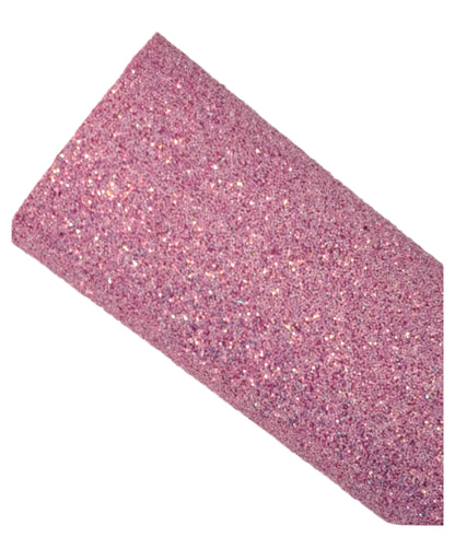 Roll of pink glitter paper on a white background
