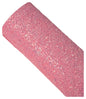 Roll of pink glittery material on a neutral background