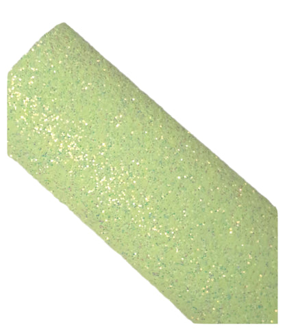 Roll of green glitter paper on a white background