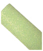 Roll of green glitter paper on a white background