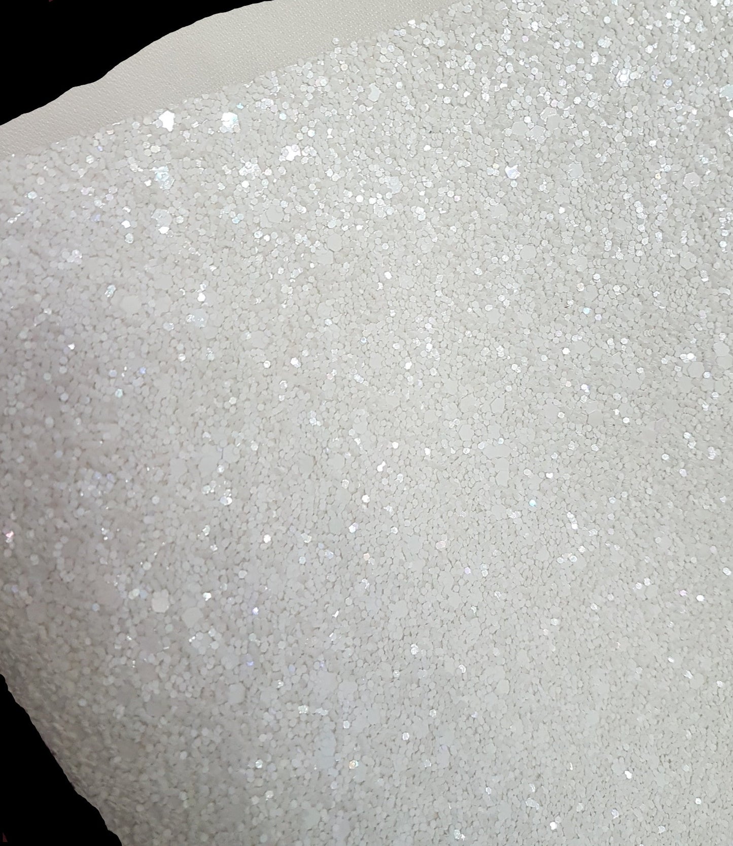 Close-up of white glittery material on a black background