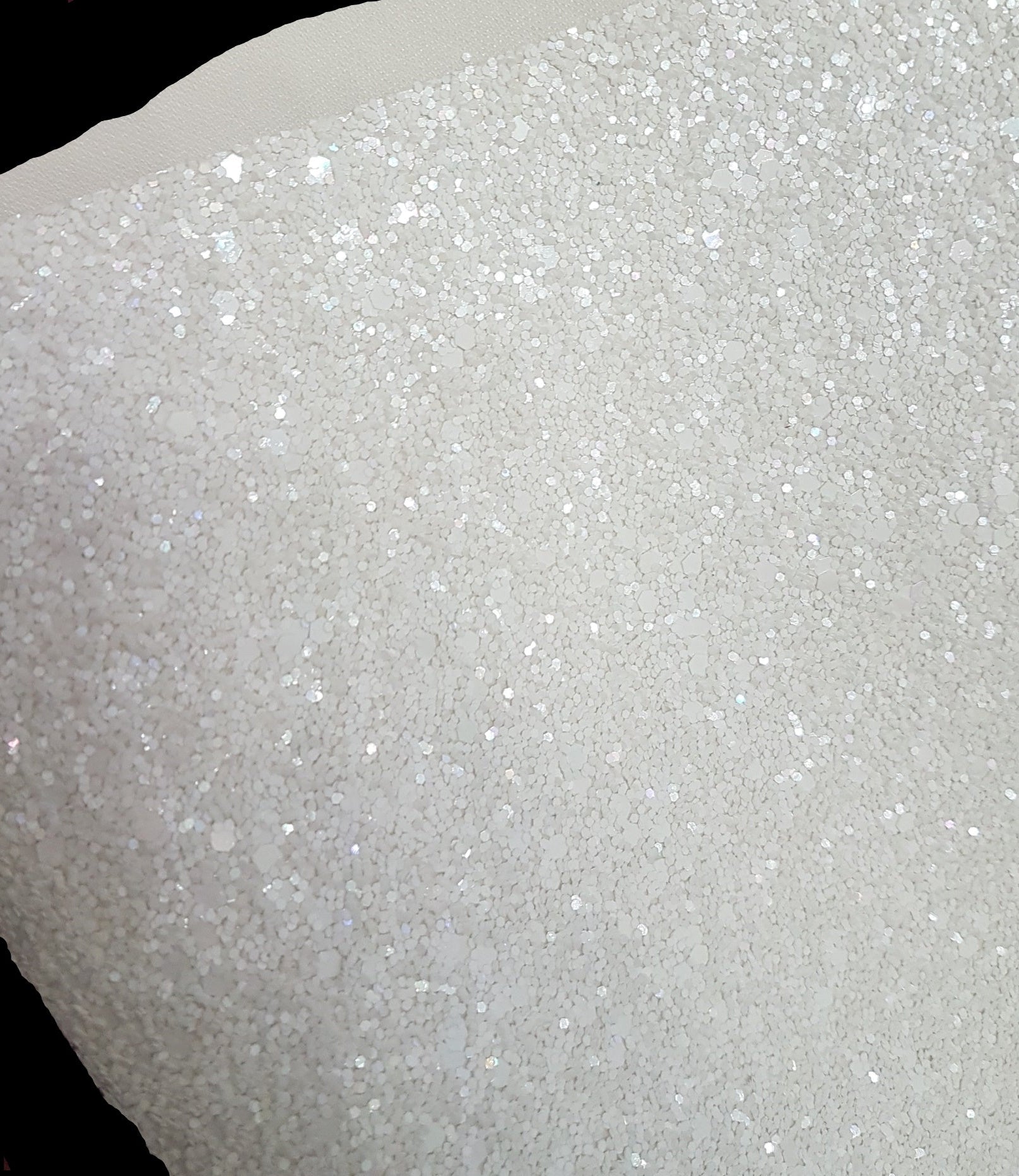Close-up of white glittery material on a black background