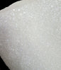 Close-up of white glittery material on a black background