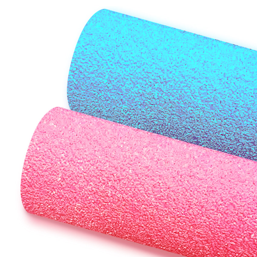 Two rolls of glittery fabric, one in blue and one in pink, placed side by side.