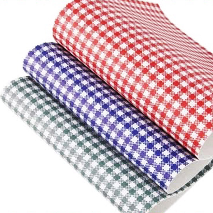 Three sheets of gingham leatherette in red, blue, and green colors, stacked on top of each other.