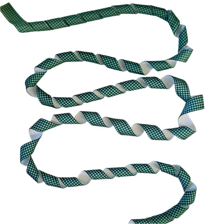 Green checkered ribbon on a textured white surface