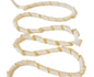 Coiled beige and white ribbon on a white background