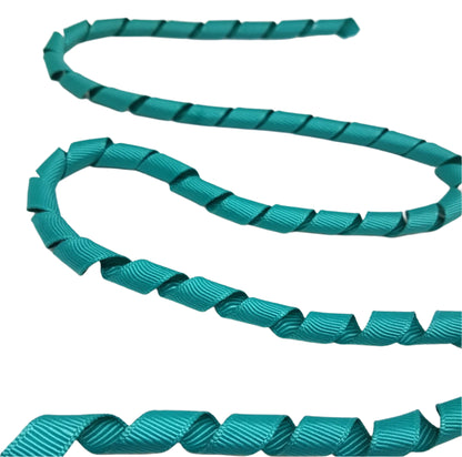 Teal ribbon with wavy pattern on a white background