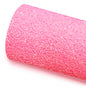 A roll of pink glitter fabric on a white background