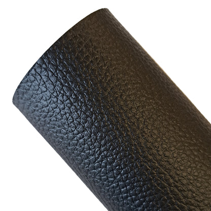 Close-up of black leather texture on a light background
