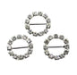 three circular brooches with rhinestone embellishments on a white background