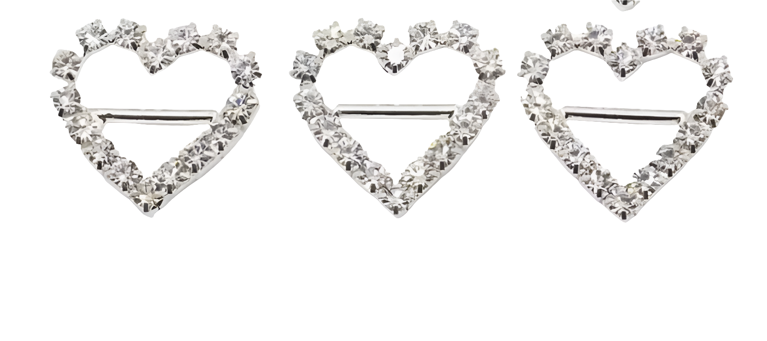 three heart-shaped brooches with diamond-like stones on a white background