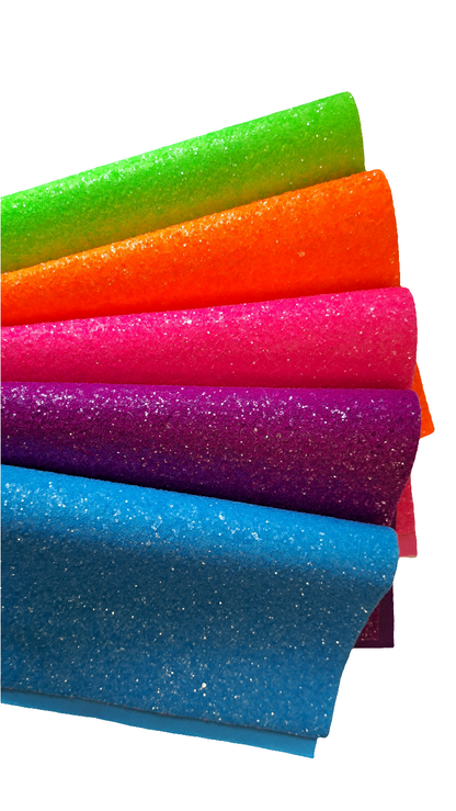 chunky glitter green orange pink purple and blue coloured sheets on a white background
