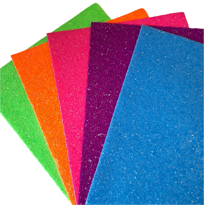 chunky glitter green orange pink purple and blue coloured sheets on a white background
