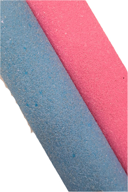 two rolls of glitter fabric one blue and one pink on a white background