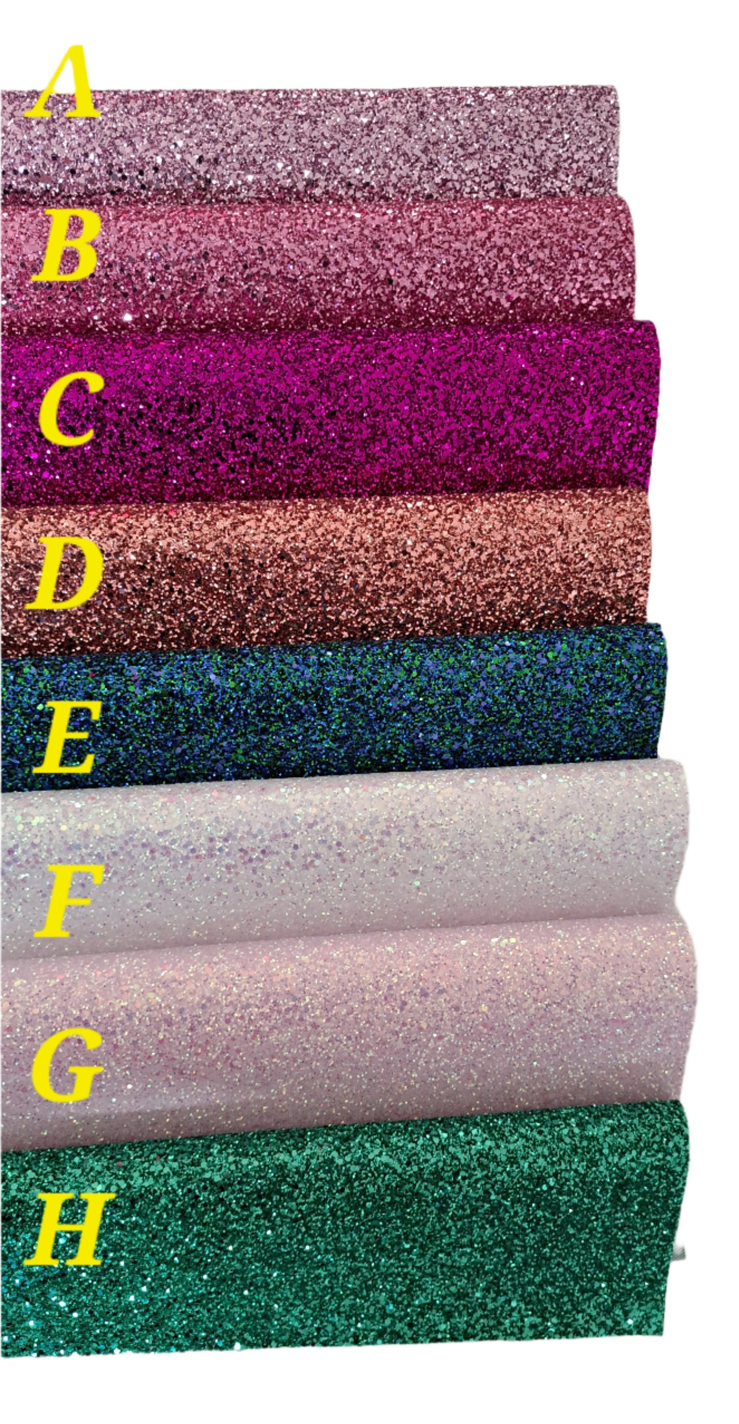chunky glitter in pink, purple, brown, green and creams colours on a white background