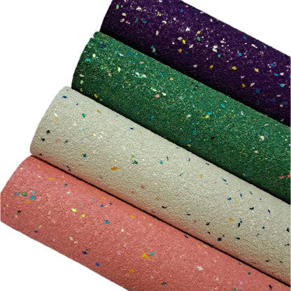 chunky glitter purple, green, cream and orange coloured rolls on a white background