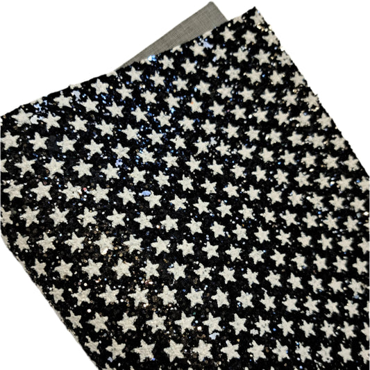 chunky glitter white stars on black coloured roll on a white background