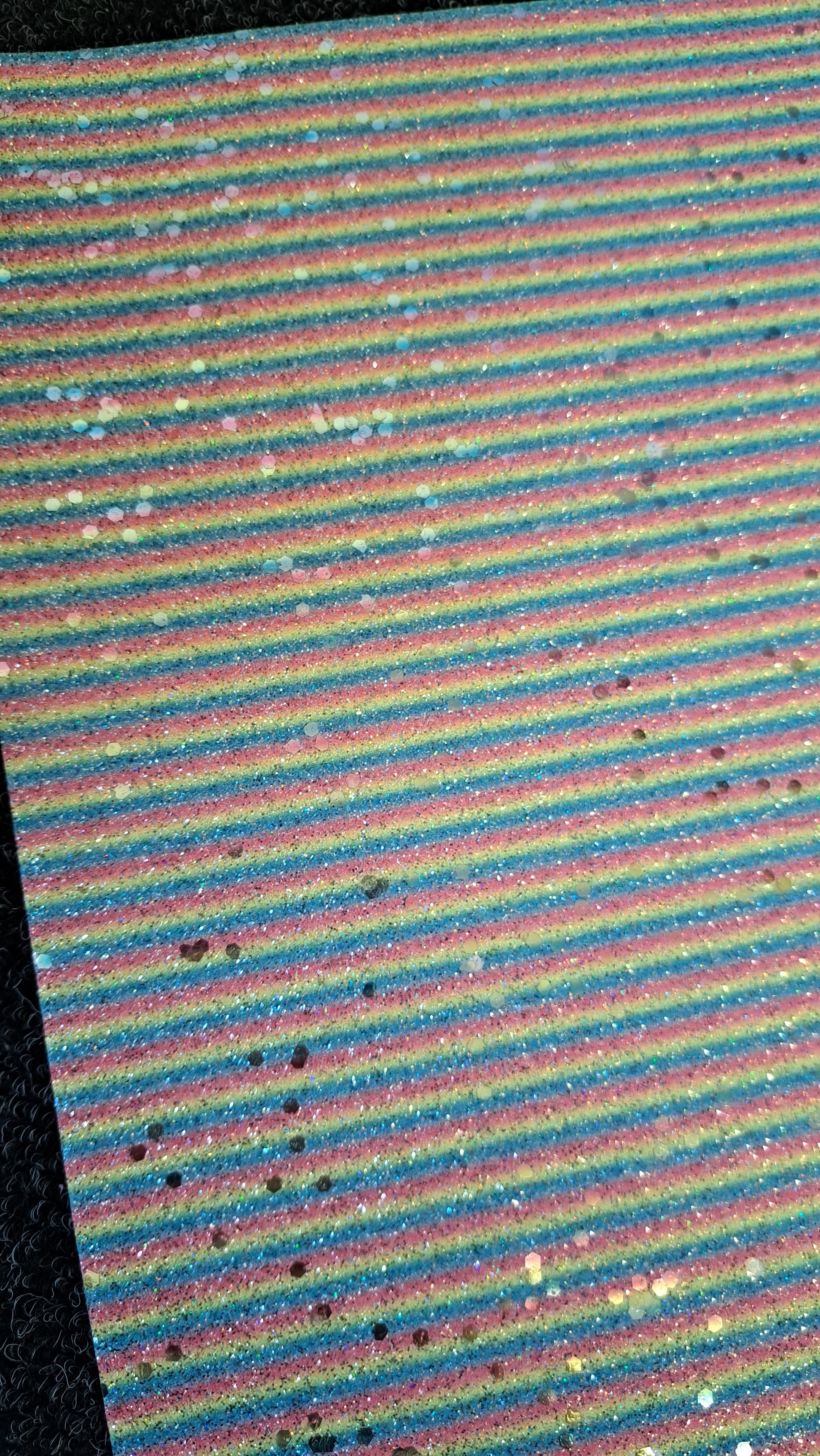 chunky glitter red, blue and yellow stripes coloured roll on a white background