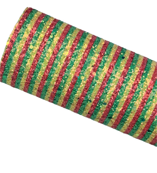 Roll of red, yellow, and green striped fabric on a textured surface
