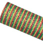 Roll of red, yellow, and green striped fabric on a textured surface