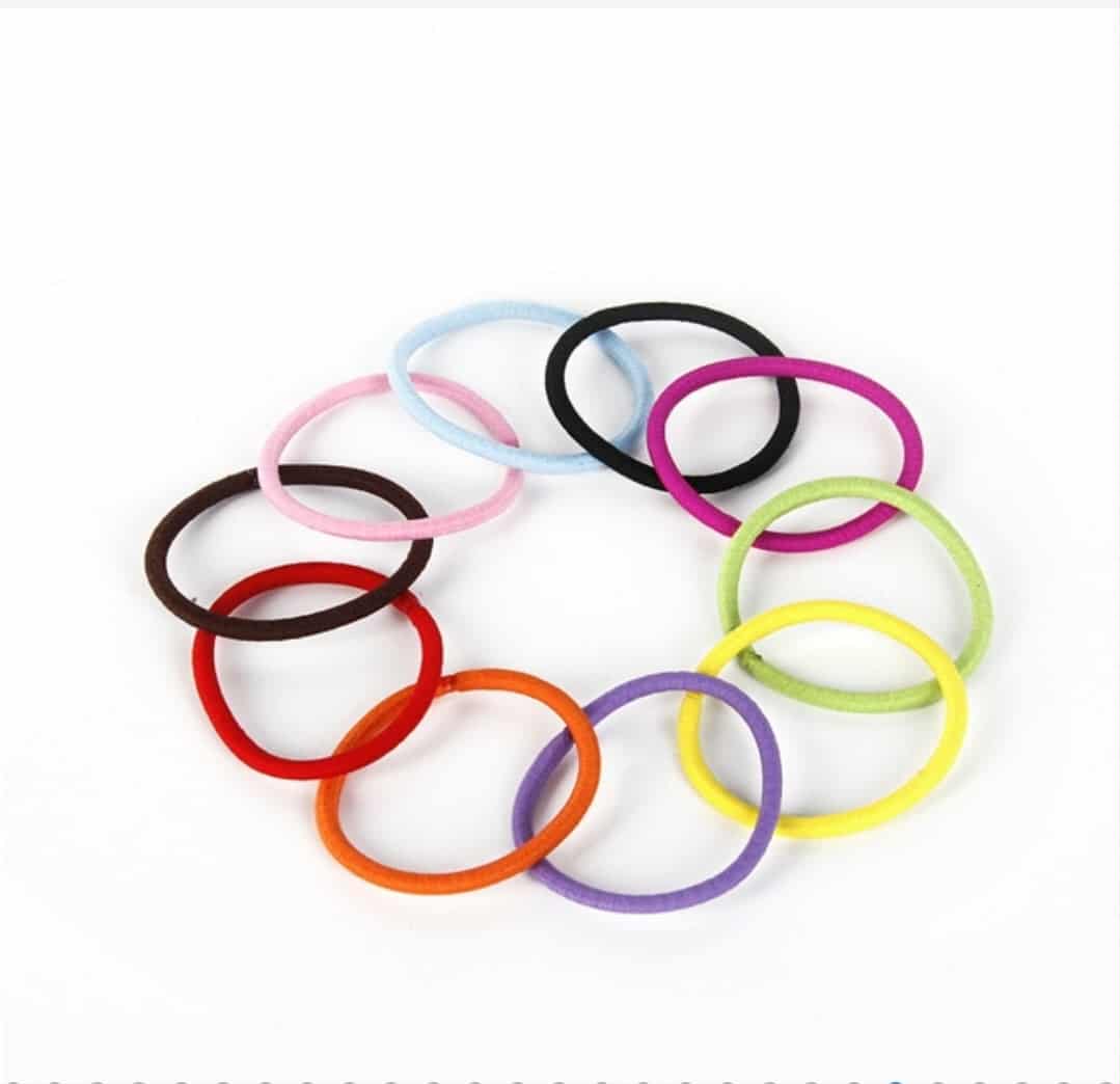 colorful hair bobbles arranged on a white background