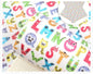 Fabric with colorful animal-themed letters on a white background