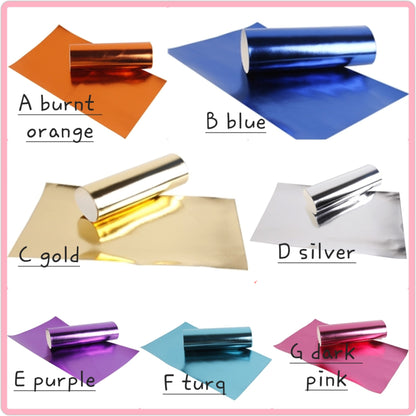 metallic ribbon in orange, blue, gold, silver, purple, turquoise and pink colour on a white background