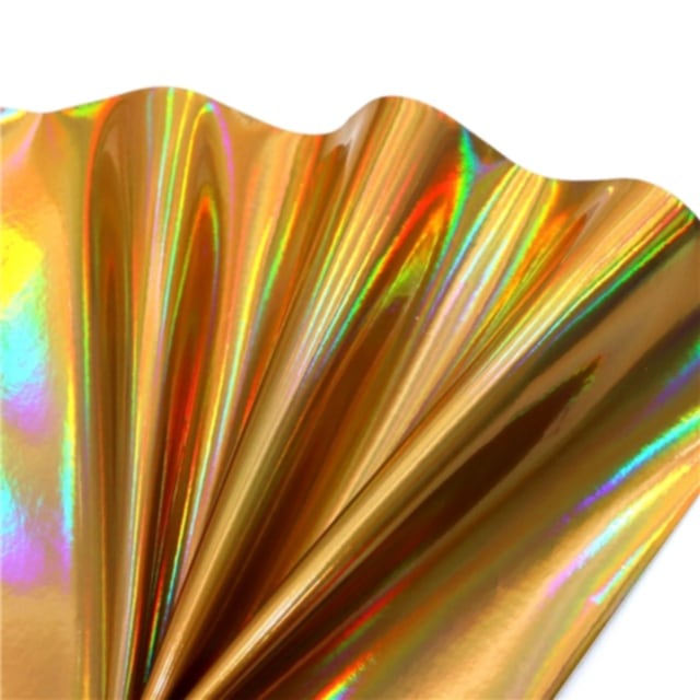 colourful mirrored metallic sheet in gold colour on a white background
