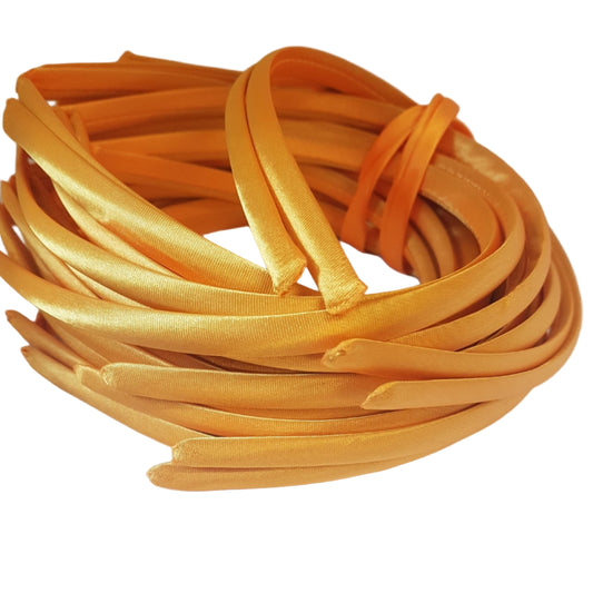 satin headbands in a dandelion colour on a white background