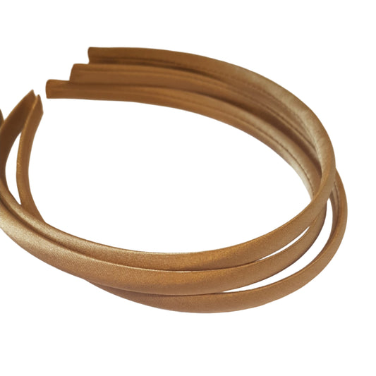 satin headbands in a tan colour on a white background