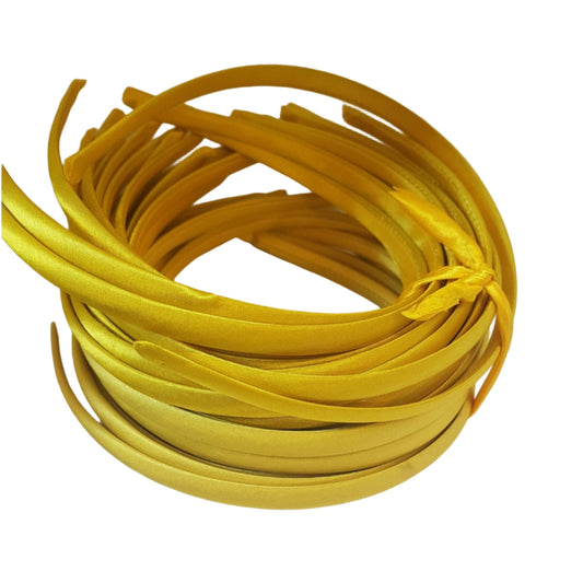 satin headbands in a yellow colour on a white background