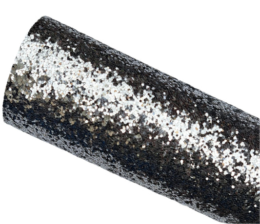 Roll of black glittery fabric on a gray background