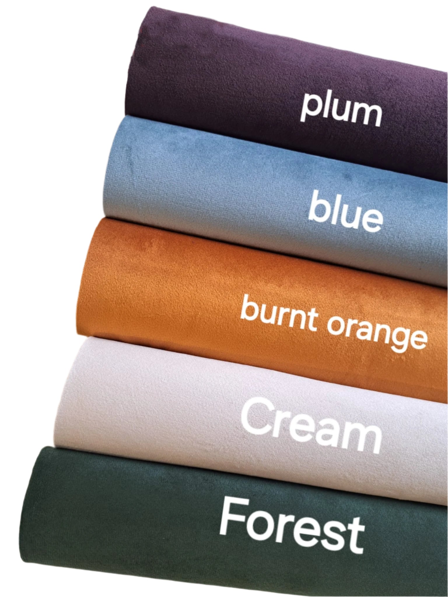 four rolls of coloured suede fabric on a white background