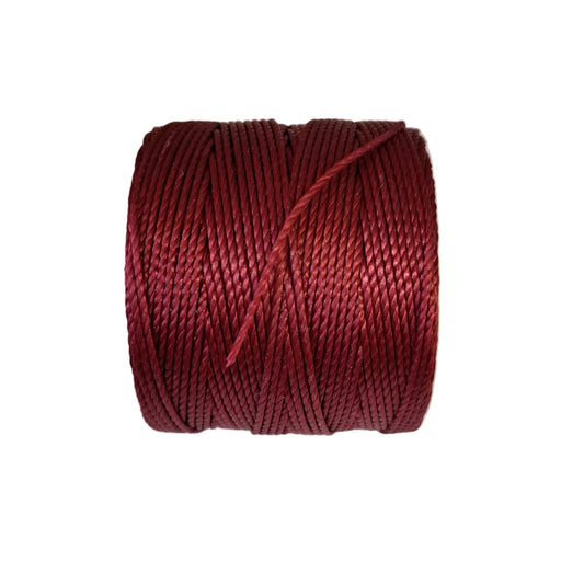 a roll of superlon bead cord in wine on a white background
