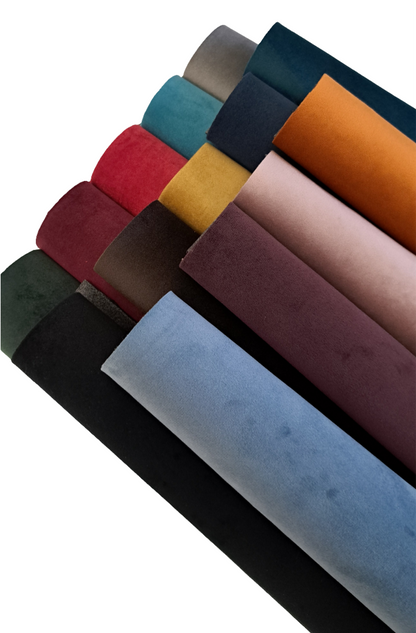 coloured velvet fabric rolls on a white background